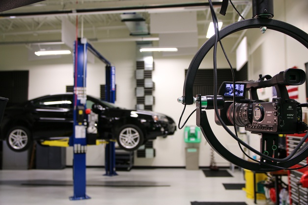 Tech Training image in the Garage with video and car